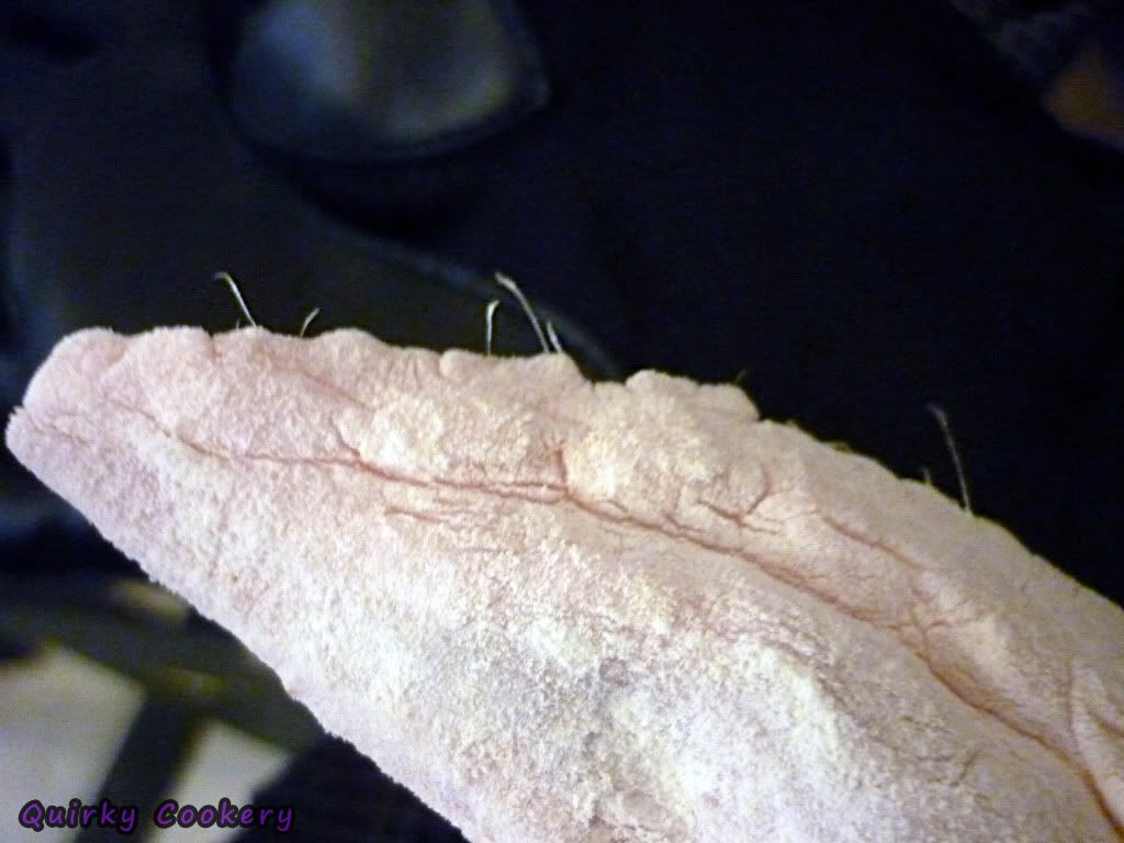 Floured turkey chicken wings with little feathers still stuck in it