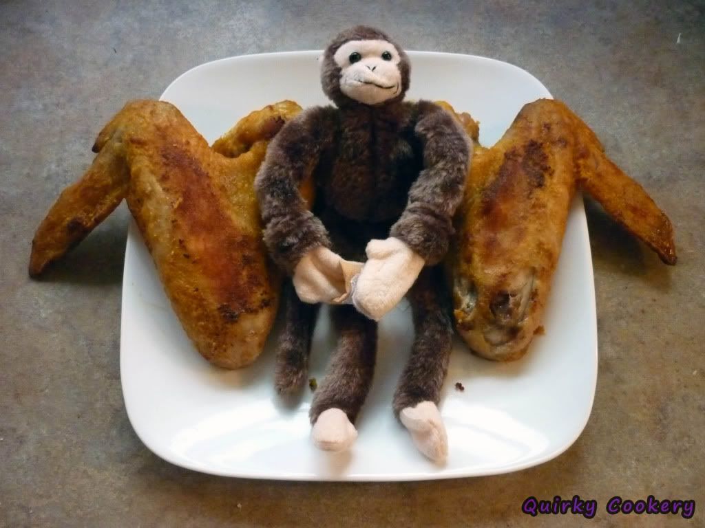 Turkey wings posed with stuffed monkey toy to look like Deathwing